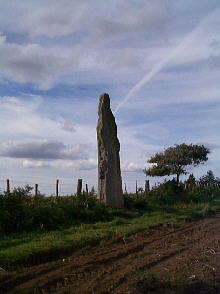 The impressive ancient menhir north of Guerlesquin set against a jet's vapour trail